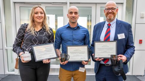 From left, Melanie Lyons, M.Eng ’22, biomedical engineer at Llume; Roy Cohen, co-founder of TETmedical; and Ricardo Garcia de Alba, CEO of Meiogenix, show the certificates and mugs they received at the April 15 incubator graduation ceremony at Weill Hall.
